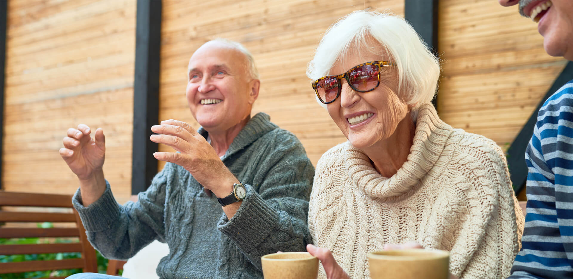 Seniors enjoying coffee and conversation in a cozy community space.